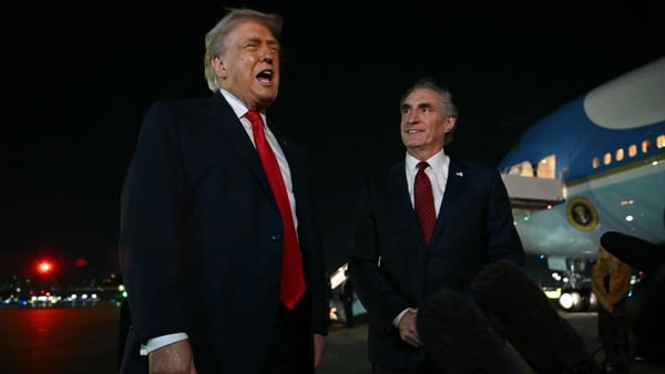 US President Donald Trump speaks with reporters before boarding Air Force One