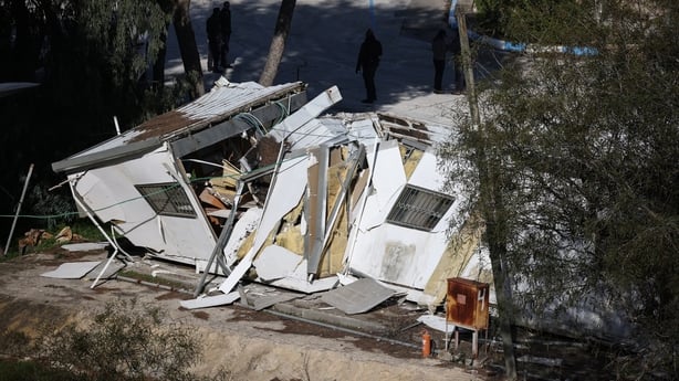 A photograph shows a demolished structure inside the headquarters of the United Nations Relief and Works Agency in Jerusalem