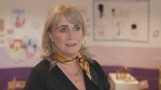 A woman speaks inside a childcare facility