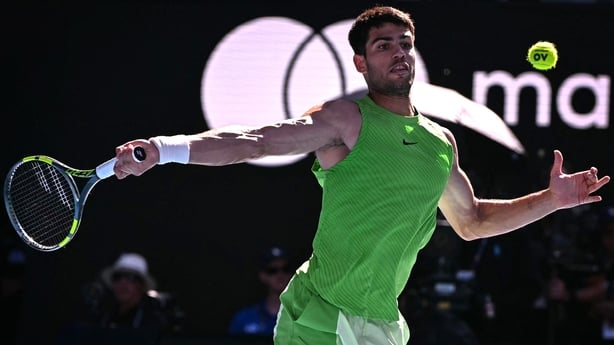 Spain's Carlos Alcaraz hits a return to Germany's Yannick Hanfmann during their men's singles match on day four of the Australian Open tennis tournament in Melbourne on January 21, 2026. 