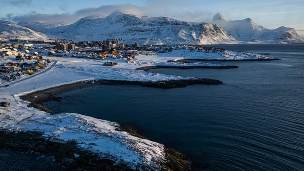 aerial view image shows the city of Nuuk covered in snow along the coastline of western Greenland