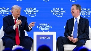 US President Donald Trump (L) speaks with World Economic Forum president and CEO Borge Brende