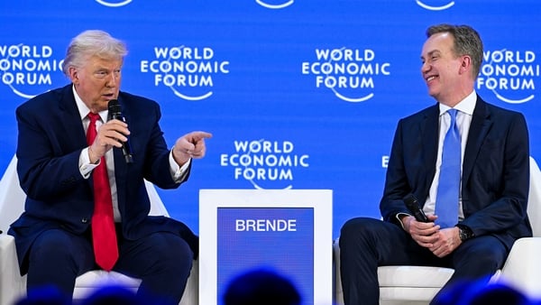 US President Donald Trump (L) speaks with World Economic Forum president and CEO Borge Brende