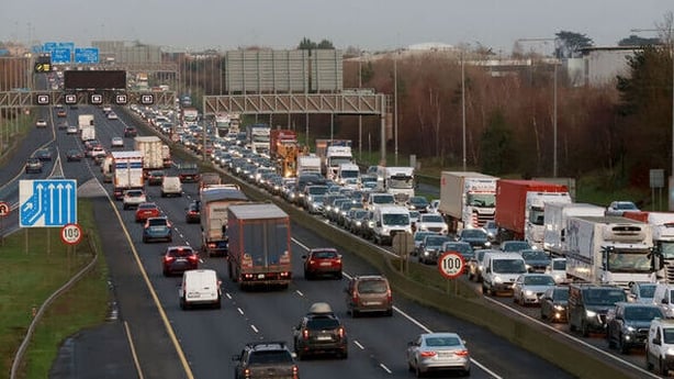 photo shows cars and heavy duty articulated trucks stuck in congested traffic on the M50 in December