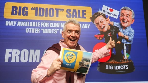 Ryanair CEO Michael O'Leary poses with a poster for a 'Big Idiot Sale'