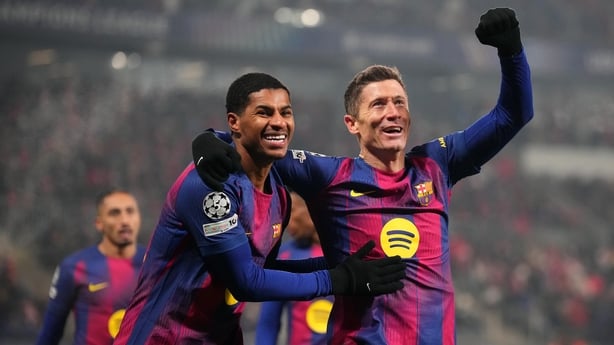Robert Lewandowski of FC Barcelona celebrates scoring his team's fourth goal with teammate Marcus Rashford during the UEFA Champions League 2025/26 League Phase MD7 match between SK Slavia Praha and FC Barcelona at Eden Arena on January 21, 2026 in Prague, Czech Republic.