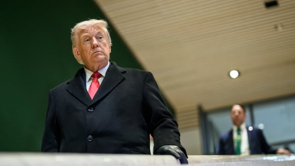 US President Donald Trump looks on