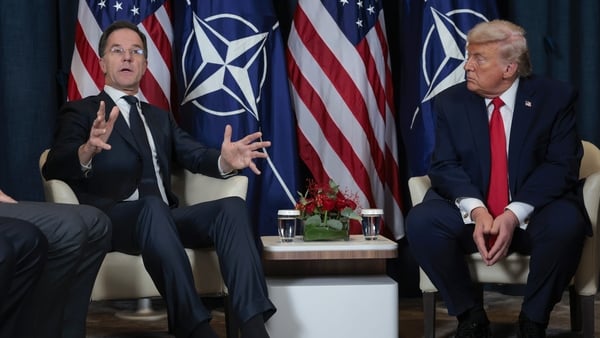 President Donald Trump (R) listens as NATO Secretary General Mark Rutte speaks during a bilateral meeting on the sidelines of the World Economic Forum