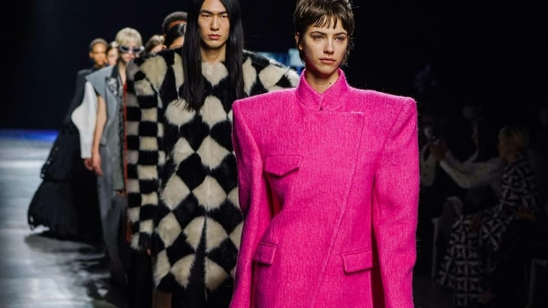 Models on the runway wearing clothing with exaggerated shoulders