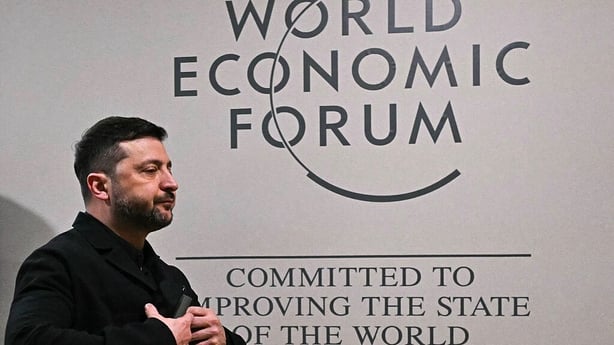 Ukraine's President Volodymyr Zelensky gestures as he walks inside the Congress Centre during the World Economic Forum (WEF) annual meeting