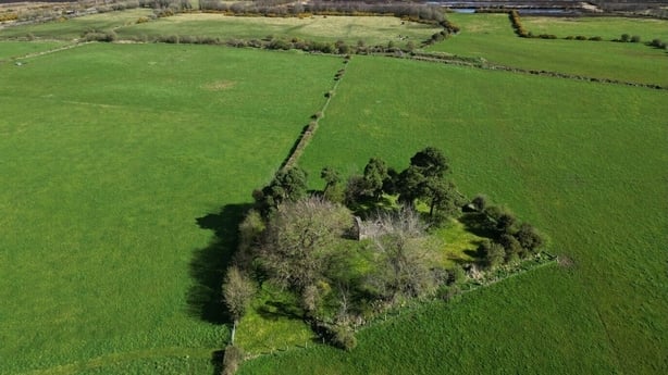 A green area surrounding an exposed burial site 