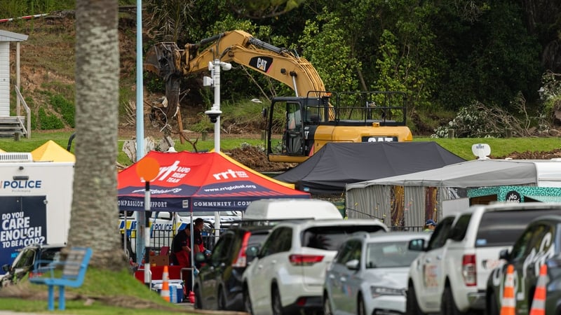 Rescuers continue to dig at the site of the landslide