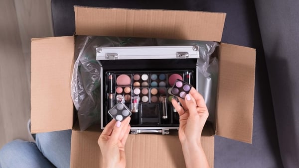 A woman unboxing cosmetics