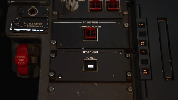 A power button for a Starlink terminal in the cockpit of a plane
