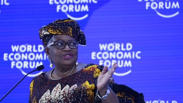 Ngozi Okonjo-Iweala on stage in Davos with the World Economic Forum signage in the background