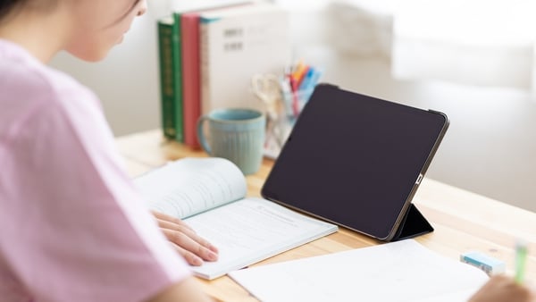 Close up image of teenager students studying in group on classroom desk