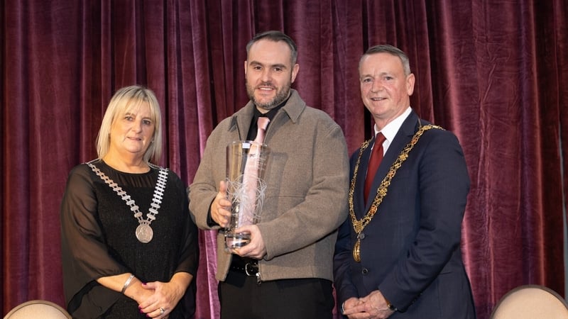 Garry McCarthy, centre, with his Cork Person of the Year award