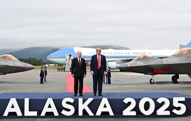In this pool photograph distributed by the Russian state agency Sputnik, US President Donald Trump and Russian President Vladimir Putin pose for photos during a US-Russia summit on Ukraine at Joint Base Elmendorf-Richardson in Anchorage, Alaska, on August 15, 2025. (Photo by Sergey Bobylev / POOL / 