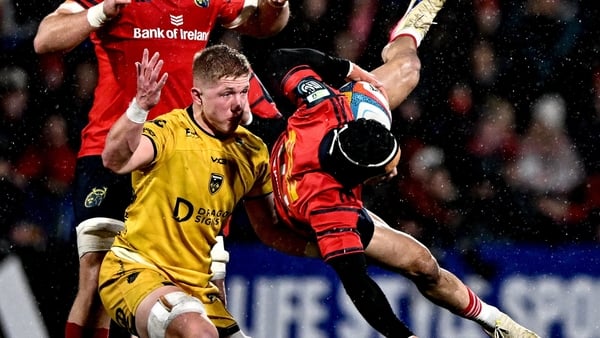 23 January 2026; Thaakir Abrahams of Munster gathers possession of the ball despite the tackle of Harry Beddall of Dragons during the United Rugby Championship match between Munster and Dragons at Virgin Media Park in Cork. Photo by Ben McShane/Sportsfile