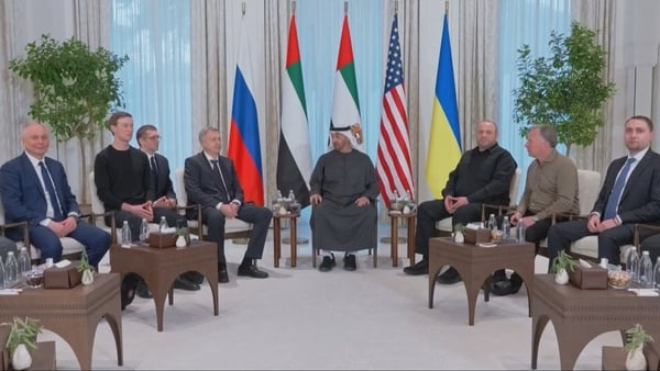Negotiaters for the US, Ukraine and Russia sit in a semi circle during talks.