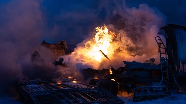 firefighters work to extinguish a fire