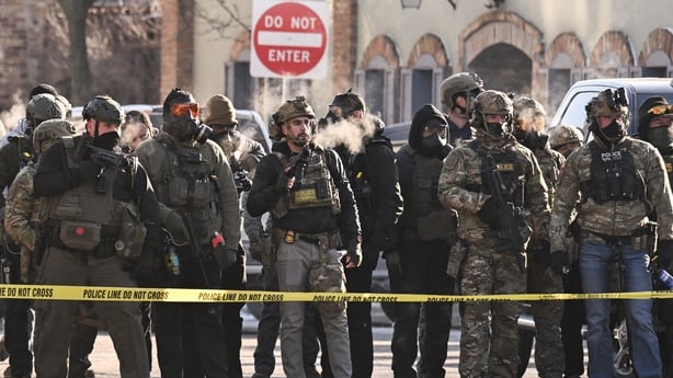 Federal agents stand behind police tape in Minneapolis