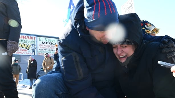 A woman cries after someone is taken away by federal agents amid protests in Minneapolis, Minnesota
