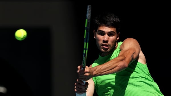 MELBOURNE, AUSTRALIA - JANUARY 25: Carlos Alcaraz of Spain plays a backhand in the men's Singles Fourth Round against Tommy Paul of the United States during day eight of the 2026 Australian Open at Melbourne Park on January 25, 2026 in Melbourne, Australi