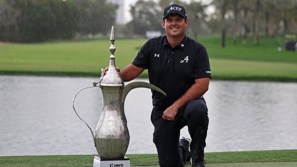 Patrick Reed of the US poses with the trophy after winning the Hero Dubai Desert Classic golf tournament at the Emirates Golf Club in Dubai on January 25, 2026. (Photo by Fadel SENNA / AFP)