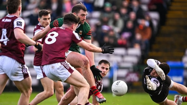 Aidan O’Shea of Mayo scores his side's first goal despite the efforts of Seán Kelly of Galway, 8, and Galway goalkeeper Connor Gleeson during the Allianz Football League Division 1 match between Galway and Mayo at Pearse Stadium in Galway.