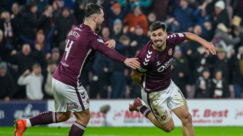 Claudio Braga (R) celebrates his goal with Hearts team-mate Craig Halkett