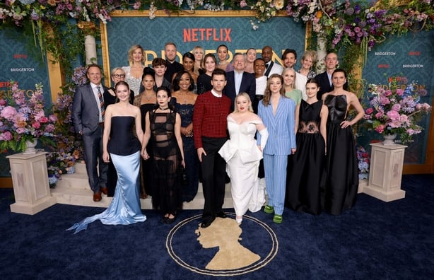 NEW YORK, NEW YORK - MAY 13: (L-R) Tom Verica, Betsy Beers, Hannah Dodd, Joanna Bobin, Bela Bajaria, Will Tilson, Harriet Cains, Sam Phillips, Shonda Rhimes, Simone Ashley, Jessica Madsen, Ruth Gemmell, Luke Newton, Emma Naomi, Ted Sarandos, Nicola Coughlan, Hannah New, Adjoa Andoh, Daniel Francis, 