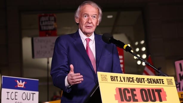 Ed Markey stands in front of podium with a sign saying "ICE out for good".