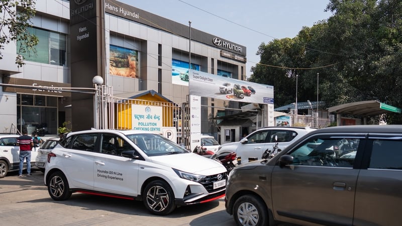 Cars stand outside a dealership in India
