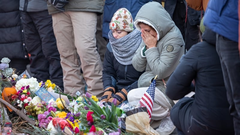 People react at a vigil for Alex Pretti in Minneapolis yesterday