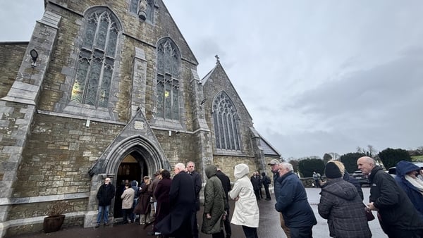 People queue outside a church