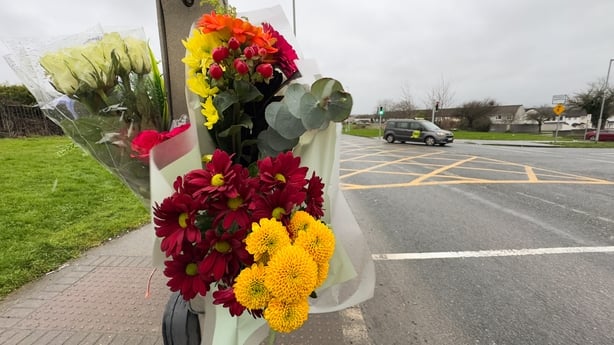 Flowers are left at the scene on Ratoath Road in Finglas, Dublin, where a 14-year-old girl died after being struck by a scrambler motorbike on Sunday afternoon