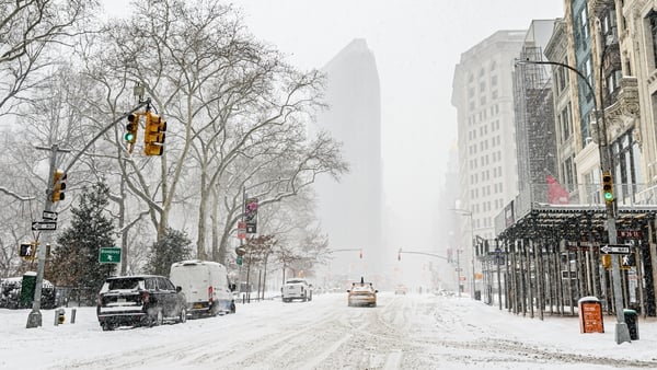 A street in New York city is covered in snow.