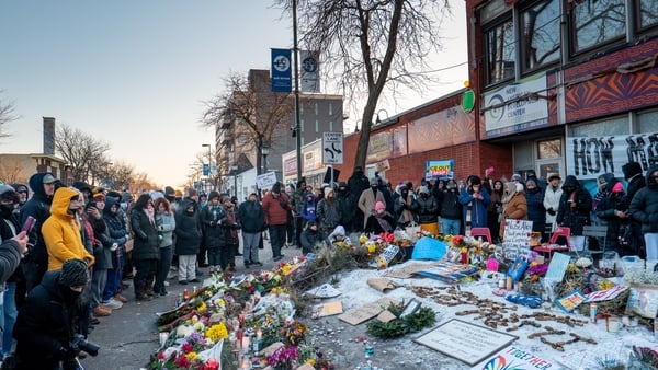 People pay their respects at a memorial site for Alex Pretti on January 25, 2026 in Minneapolis, Minnesota. Pretti was shot and killed by federal agents amid a scuffle to arrest him on January 24. The Trump administration has sent a reported 3,000 federal
