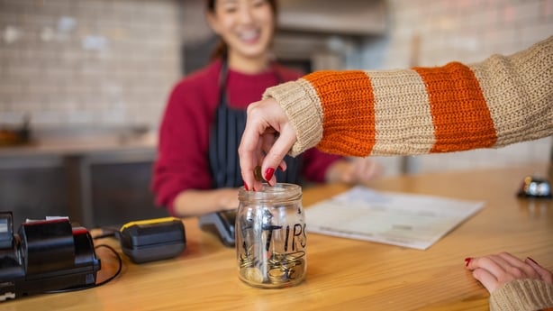 Customer leaving the tips at the tip jar
