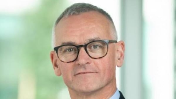 headshot of Alan Barrett who has grey hair and wearing dark framed glasses