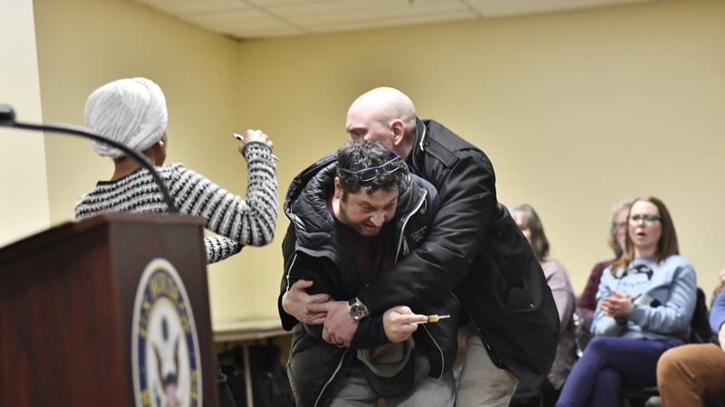 A man is tackled after he sprayed liquid at Ilhan Omar