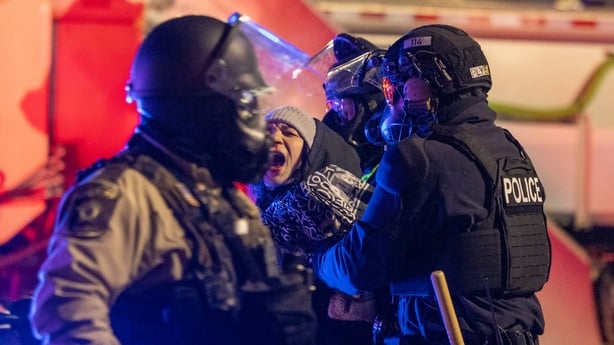 MINNEAPOLIS, UNITED STATES - JANUARY 26: Protesters clash with law enforcement while holding a 'noise demonstration' outside of a hotel believed to be housing federal immigration agents near Minneapolis, United States, on January 26, 2025. (Photo by Arthur Maiorella/Anadolu via Getty Images)