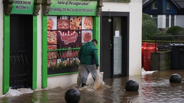 A person walking through floodwater in Enniscorthy