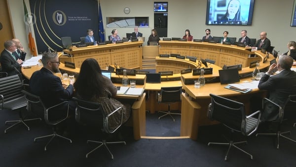 People sit around a raised circular desk