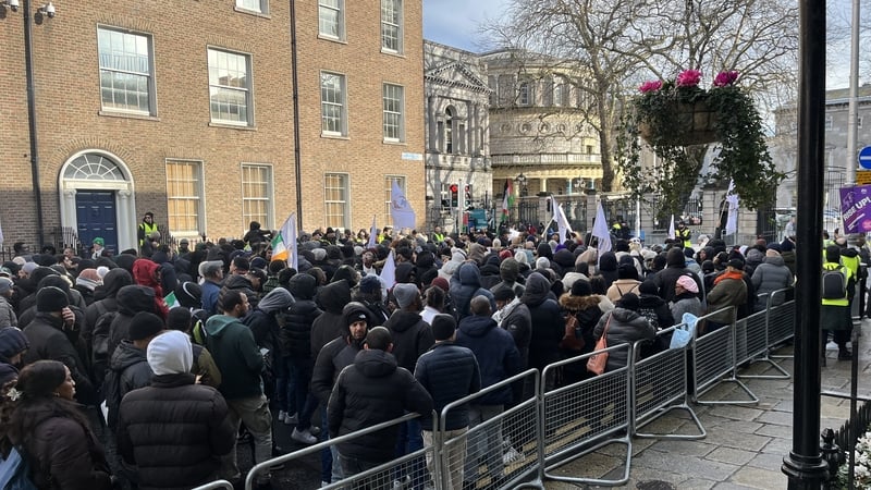 Many of those protesting carried flags with 'Stop Deportations' written across them