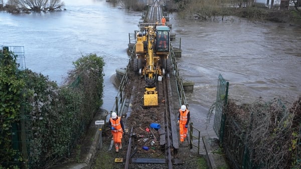Irish Rail workers clear debris from the line in Enniscorthy