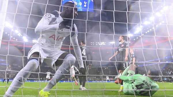 Tottenham Hotspur's Randal Kolo Muani (L) scores his team's first goal during the UEFA Champions League league phase- day 8 football match between Eintracht Frankfurt and Tottenham Hotspur in Frankfurt, western Germany, on January 28, 2026