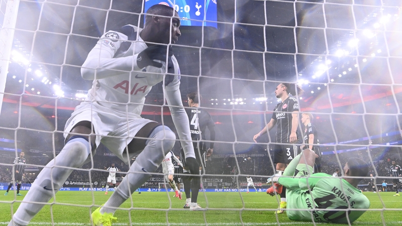 Tottenham Hotspur's Randal Kolo Muani (L) scores his team's first goal during the UEFA Champions League league phase- day 8 football match between Eintracht Frankfurt and Tottenham Hotspur in Frankfurt, western Germany, on January 28, 2026