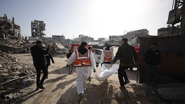 Civil defence and forensic teams exhume the bodies of dozens of Palestinians killed during Israeli attacks
